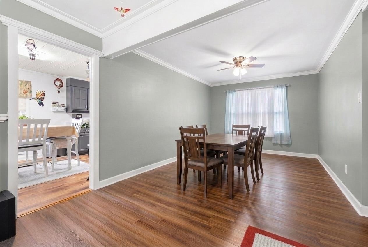 2665 Powell Chapel Road Middleton, TN 38052 - Photo 7 of 36 Dining area with wood-finish flooring, light gray wall paint, and white crown molding