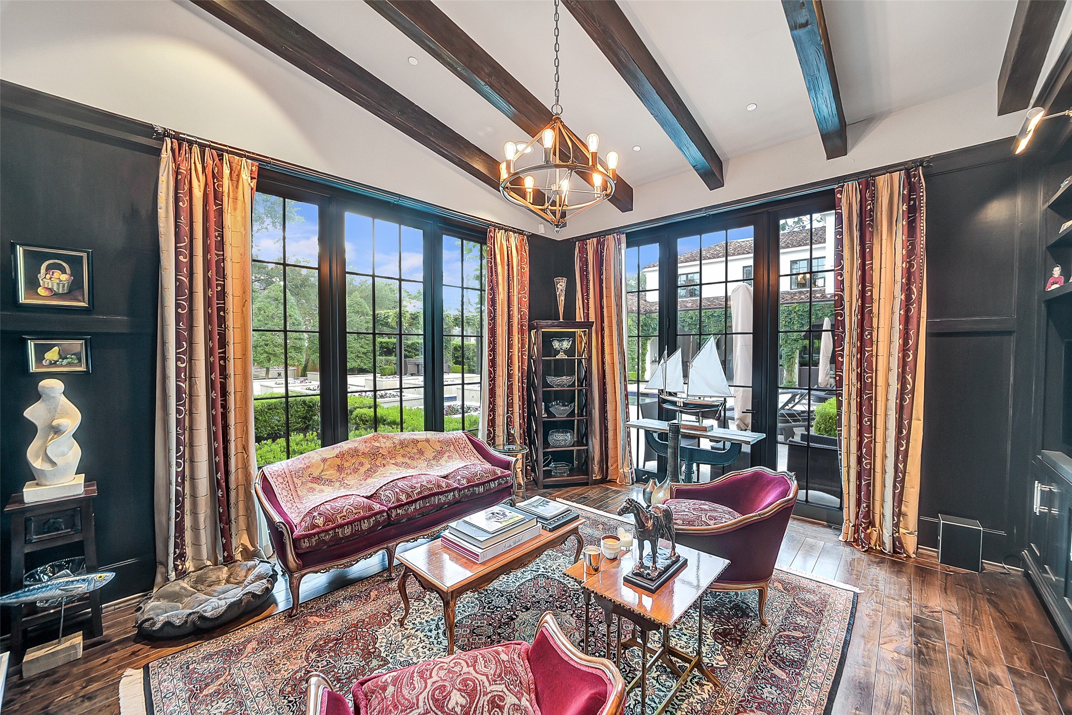 252 Piney Point Road Houston, TX 77024 - Photo 13 of 46 Beautifully appointed with beamed ceilings and rich wood paneling, the study is surrounded by windows and glass doors that overlook the terrace and backyard.