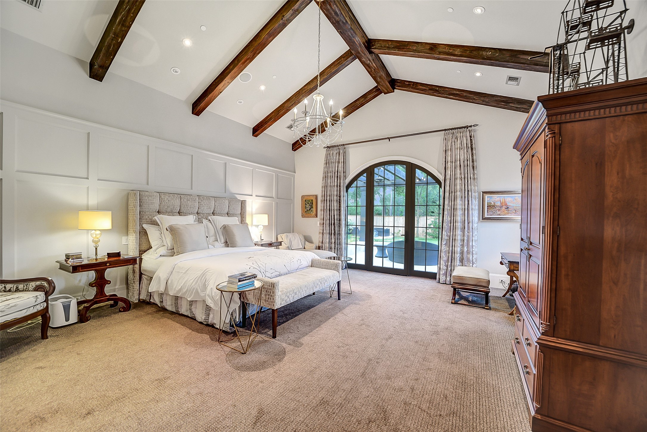 252 Piney Point Road Houston, TX 77024 - Photo 14 of 46 Privately situated in its own wing, the primary suite exudes timeless sophistication with a soring beamed ceiling and refined paneling.