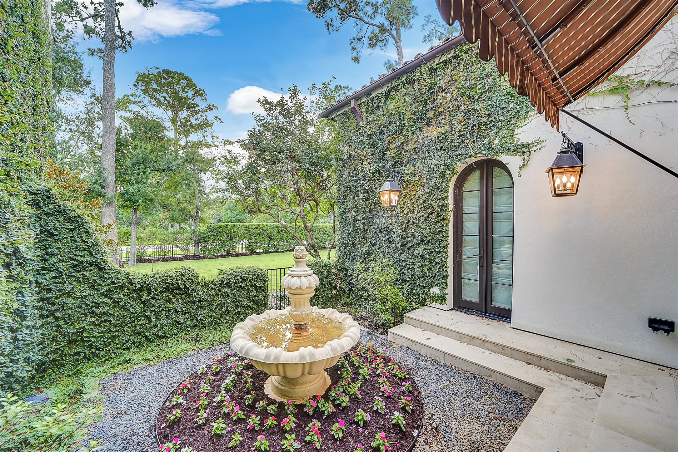 252 Piney Point Road Houston, TX 77024 - Photo 19 of 46 Tucked within the primary suite wing just off the study, a secluded courtyard showcases an exquisite fountain.