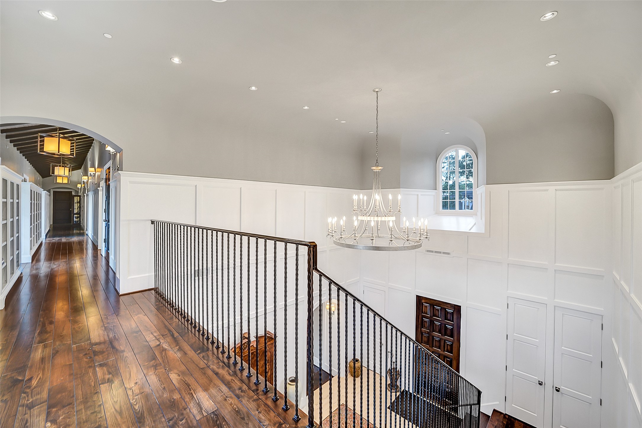 252 Piney Point Road Houston, TX 77024 - Photo 20 of 46 The grand staircase leads to an expansive gallery stretching the length of the residence connecting to three of the five guest bedroom suites.