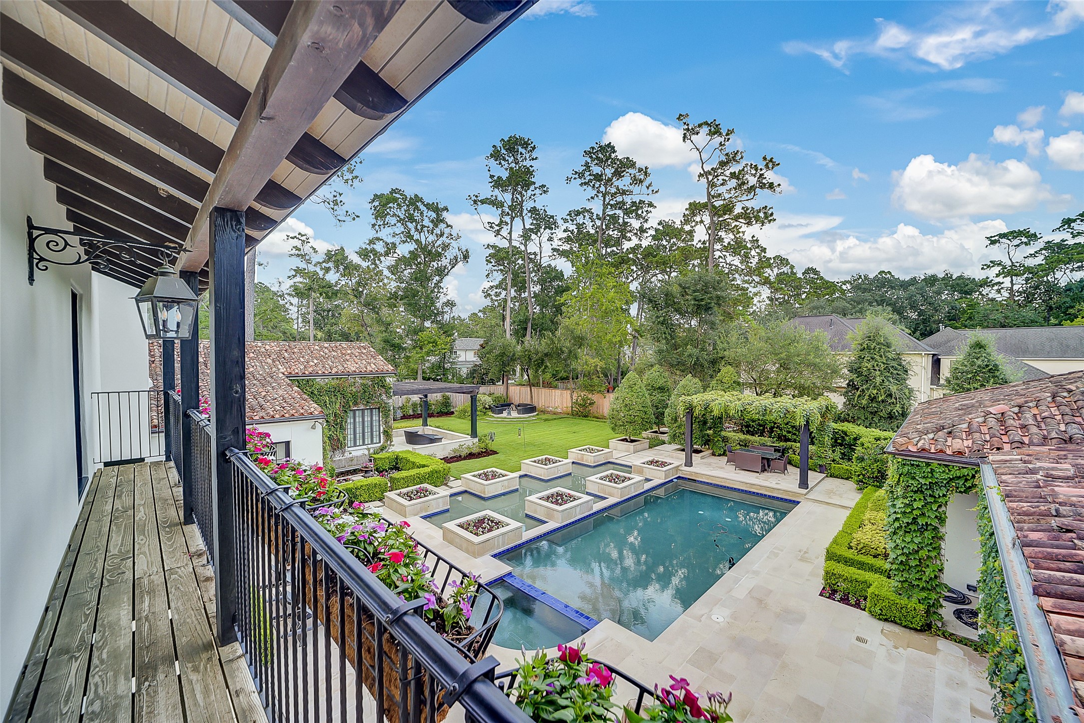 252 Piney Point Road Houston, TX 77024 - Photo 21 of 46 Enjoy captivating views of the resort-style pool from the balcony off the gallery.