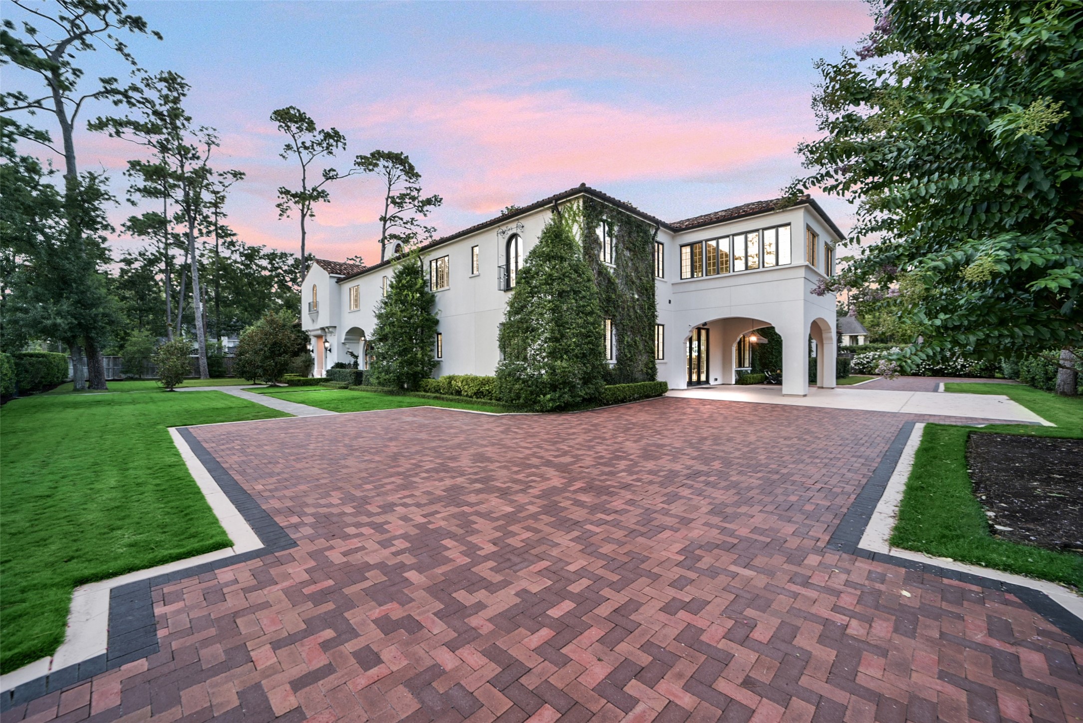 252 Piney Point Road Houston, TX 77024 - Photo 25 of 46 Enter the beautifully paved brick motor court secured by an electric gate accesses the porte cochere and three-car garage. Note the sunporch above the porte cochere.