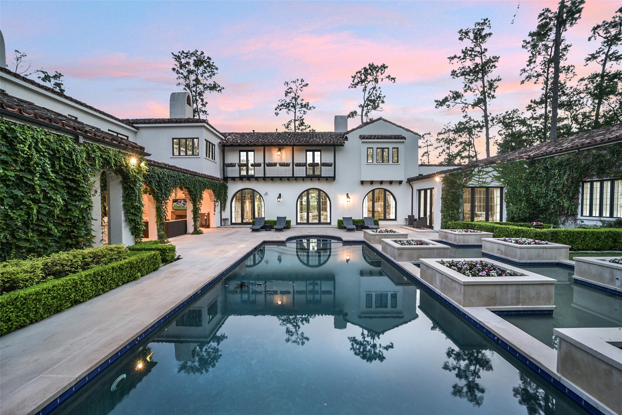 252 Piney Point Road Houston, TX 77024 - Photo 30 of 46 The full-length resort style pool is perfect for swimming laps or enjoying time with the family, combining fitness and fun in a luxurious setting.