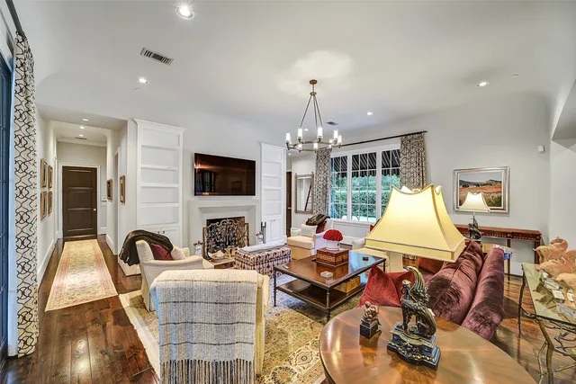 a bed sitting in a spacious bedroom next to a window