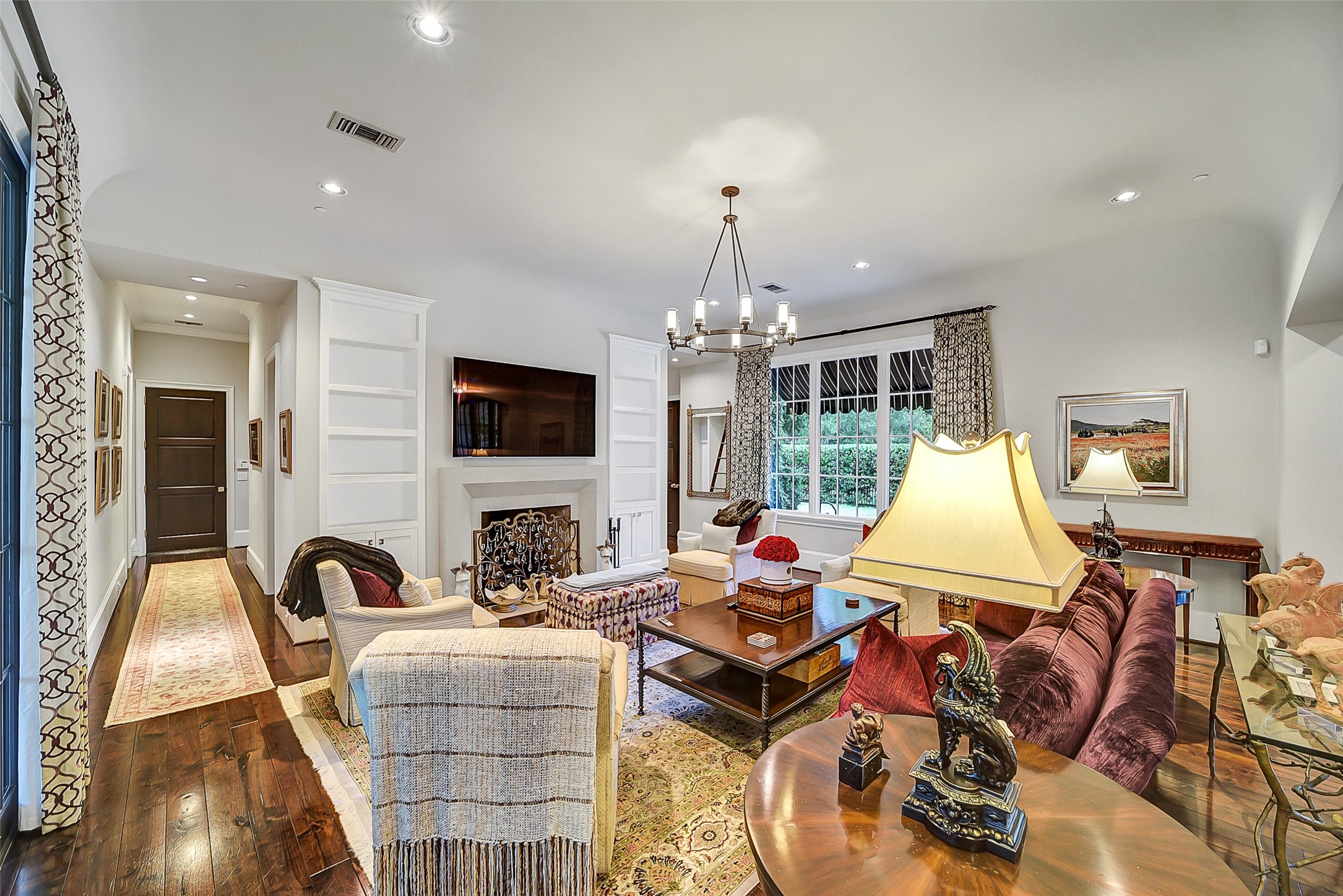 252 Piney Point Road Houston, TX 77024 - Photo 36 of 46 Expansive family room with masonry fireplace is complimented by the built-in media and display cabinetry