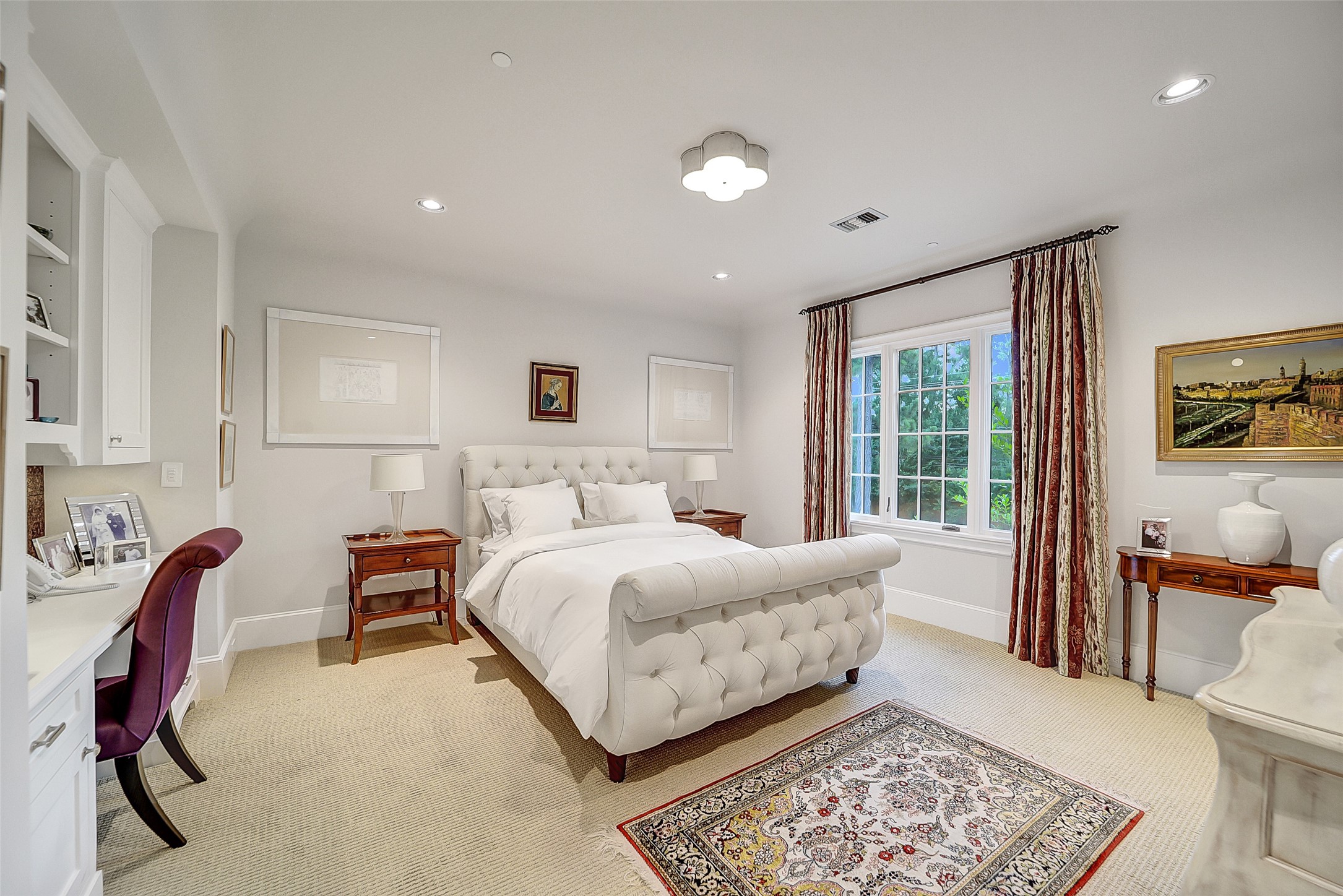 252 Piney Point Road Houston, TX 77024 - Photo 40 of 46 Additional spacious bedroom features a built-in desk and is filled with natural light, creating a warm and inviting retreat.