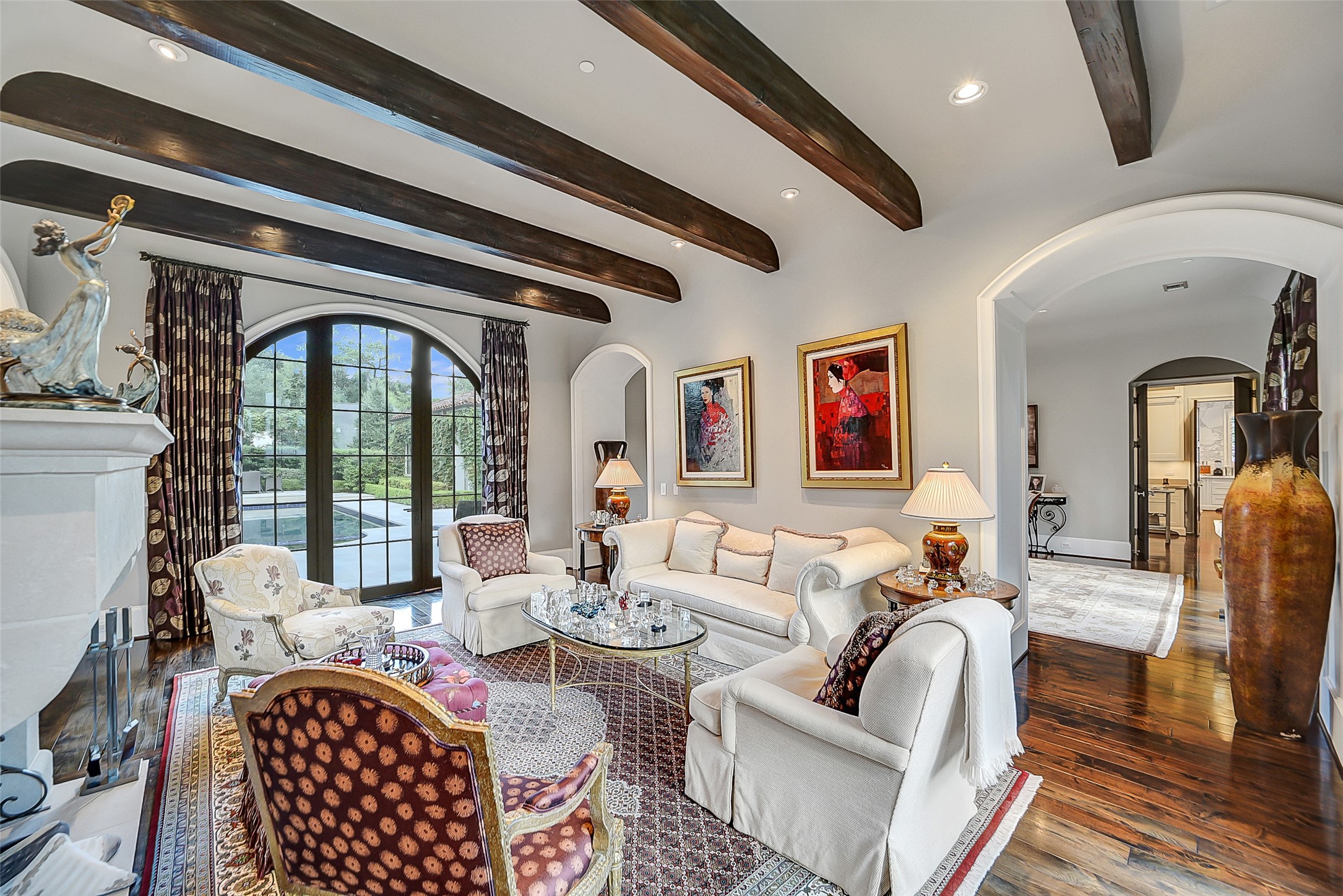 252 Piney Point Road Houston, TX 77024 - Photo 4 of 46 Elegant wide plank hardwood floors and stately masonry fireplace with limestone mantle define the formal living room. Architectural Palladian-style doors on either side of the living room offer stunning views.