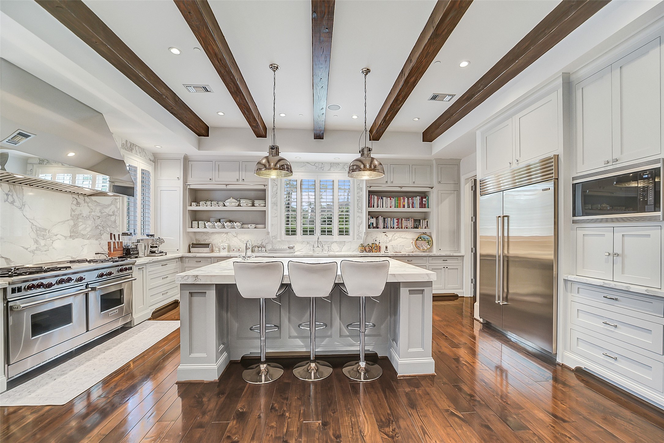 252 Piney Point Road Houston, TX 77024 - Photo 6 of 46 This showstopping kitchen features Calcutta Gold marble countertops and backsplash, oversized Sub-Zero refrigerator, two dishwashers and beamed ceilings.