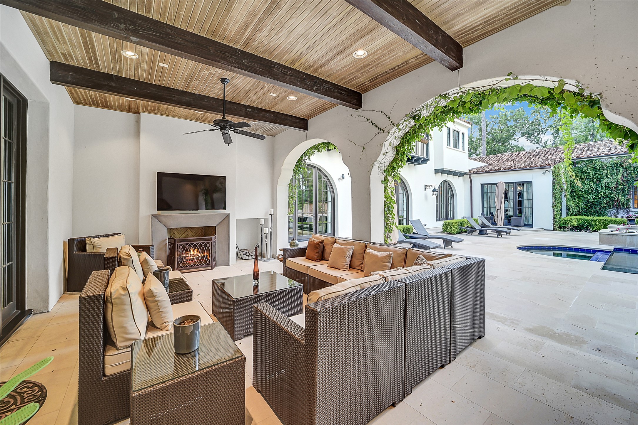 252 Piney Point Road Houston, TX 77024 - Photo 10 of 46 The generous covered loggia features a gas-burning fireplace and spacious seating area. This creates an inviting outdoor living space ideal for year-round enjoyment.
