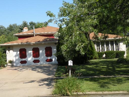 a front view of house with yard and trees