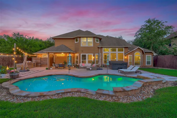 a view of a house with swimming pool and a yard