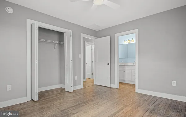 an empty room with wooden floor and closet