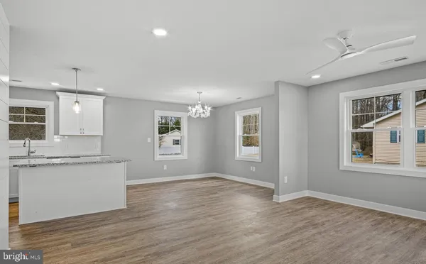 a view of a kitchen with a sink hardwood floor and a large window