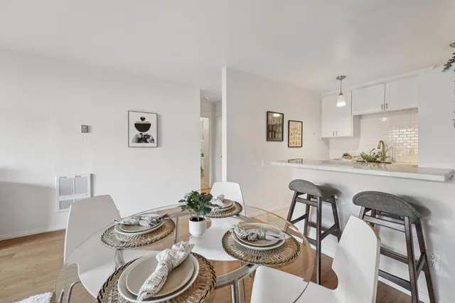 a dining room with furniture and wooden floor