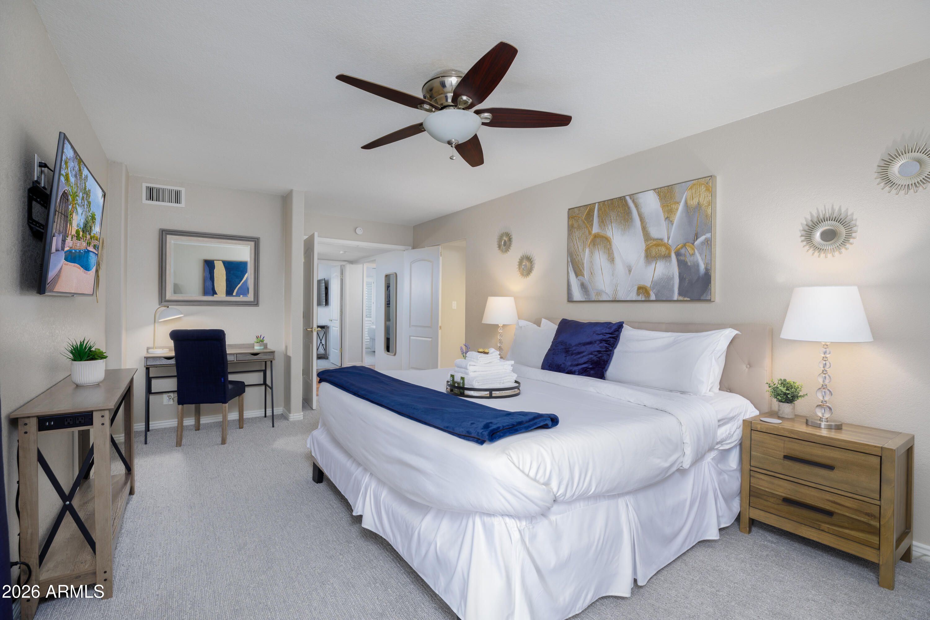 6932 East Presidio Road Scottsdale, AZ 85254 - Photo 18 of 30 a spacious bedroom with a bed and a table