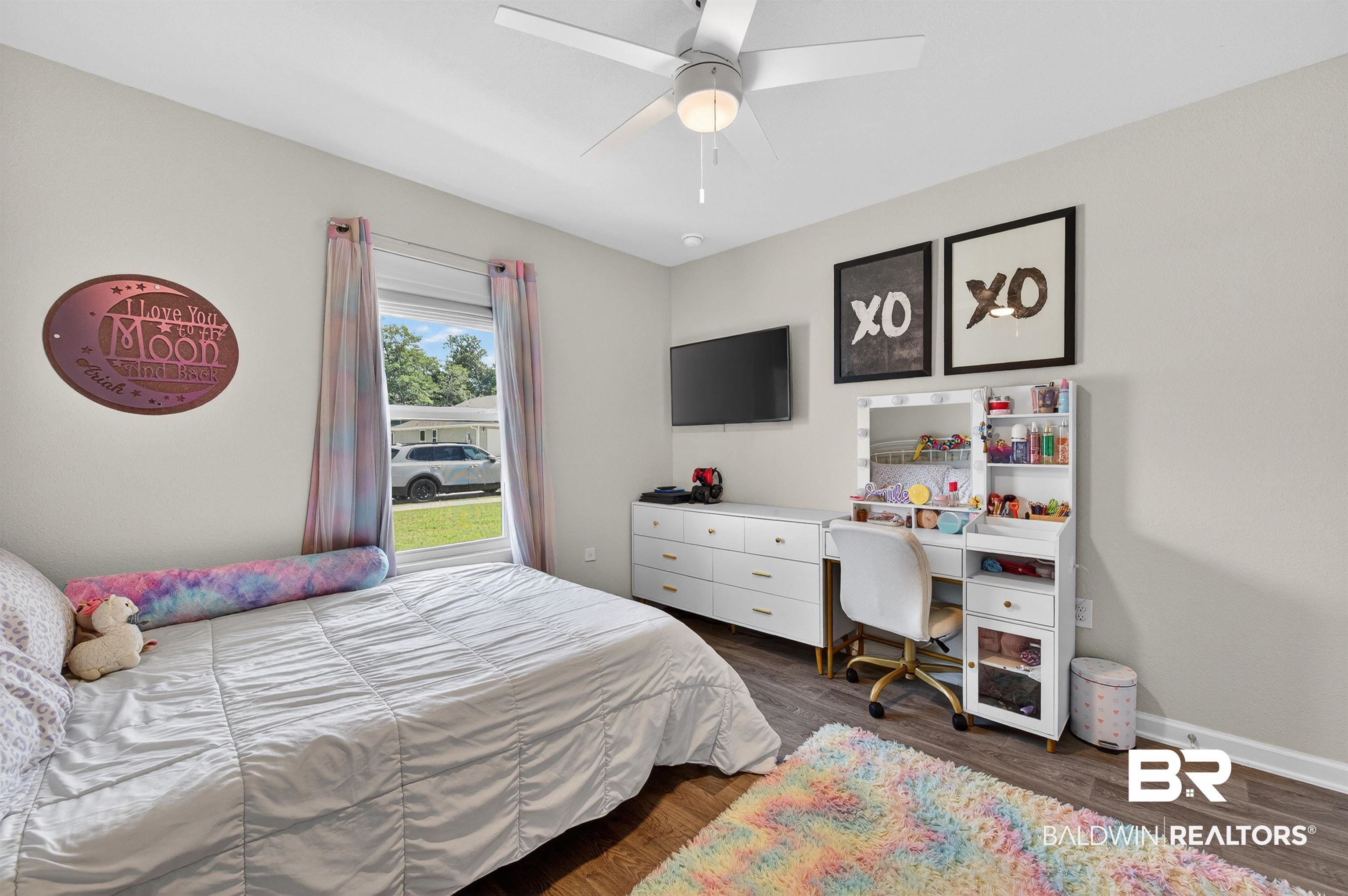 3213 Camino Real Loop Lillian, AL 36549 - Photo 56 of 61 Bedroom featuring wood-finish flooring, a ceiling fan with integrated lighting, a window with curtains, and light-toned walls