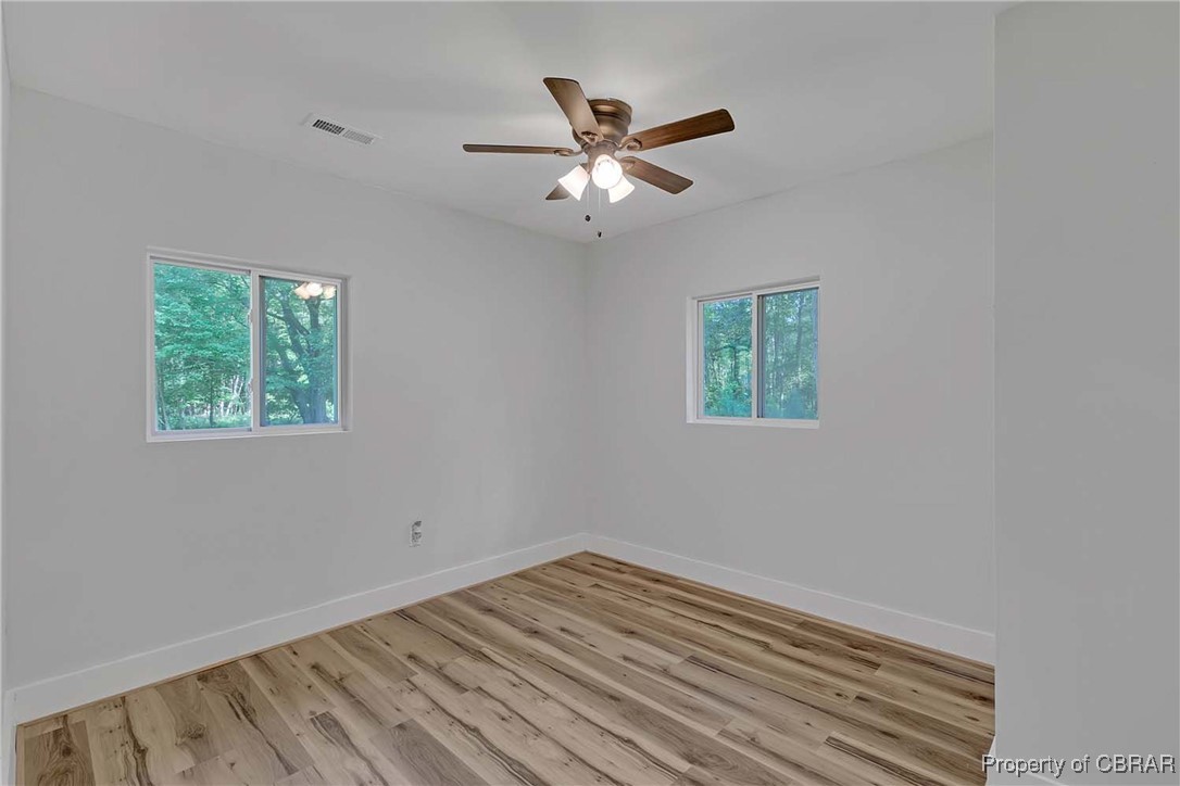 830 Glebe Road Mathews, VA 23109 - Photo 11 of 17 a view of a room with wooden floor and ceiling fan