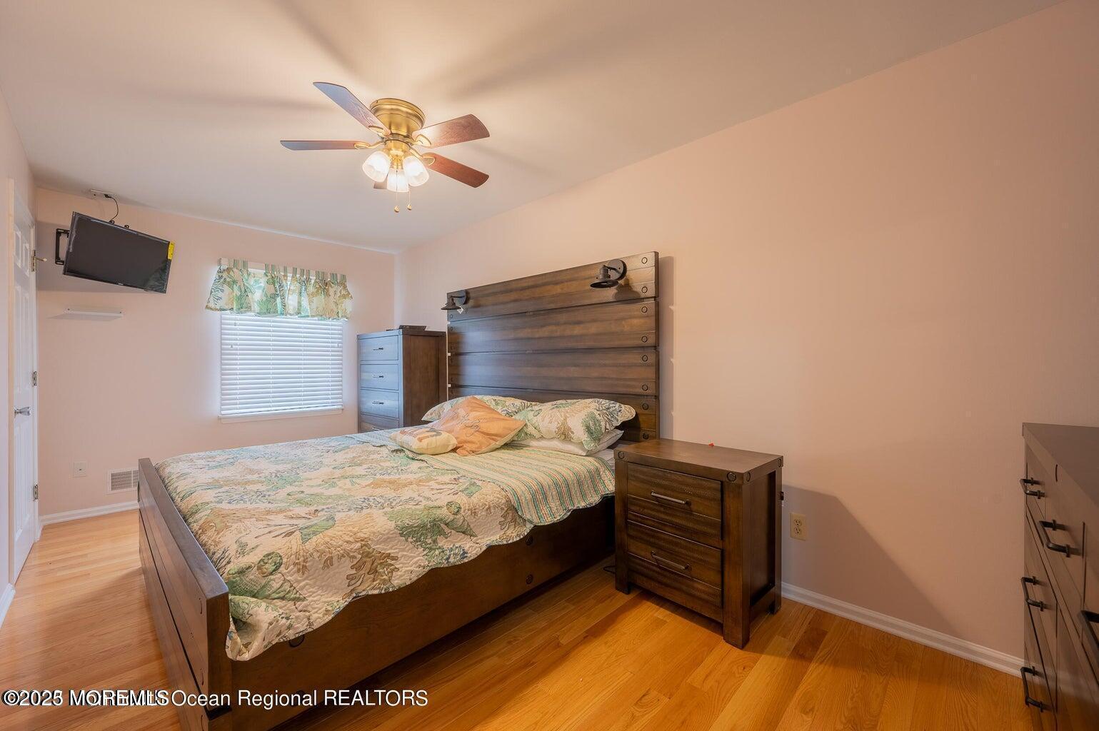 204 Coolidge Avenue Seaside Heights, NJ 08751 - Photo 11 of 22 a bedroom with a bed and a chandelier