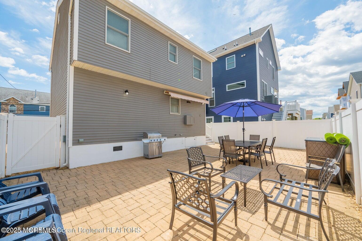204 Coolidge Avenue Seaside Heights, NJ 08751 - Photo 4 of 22 a view of a patio with a table and chairs under an umbrella
