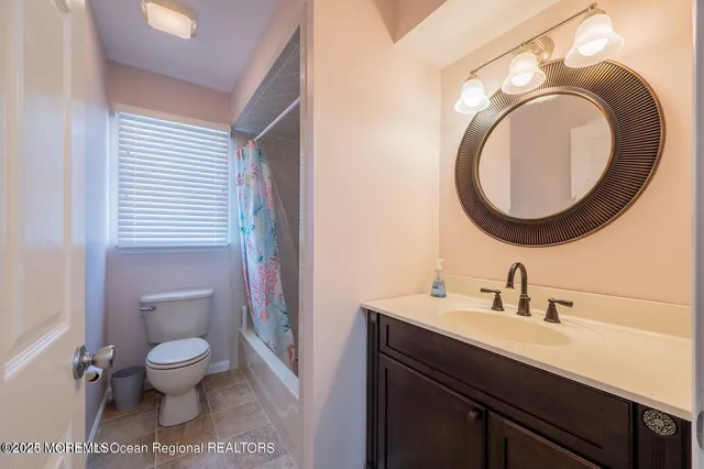 a bathroom with a toilet a sink and a mirror