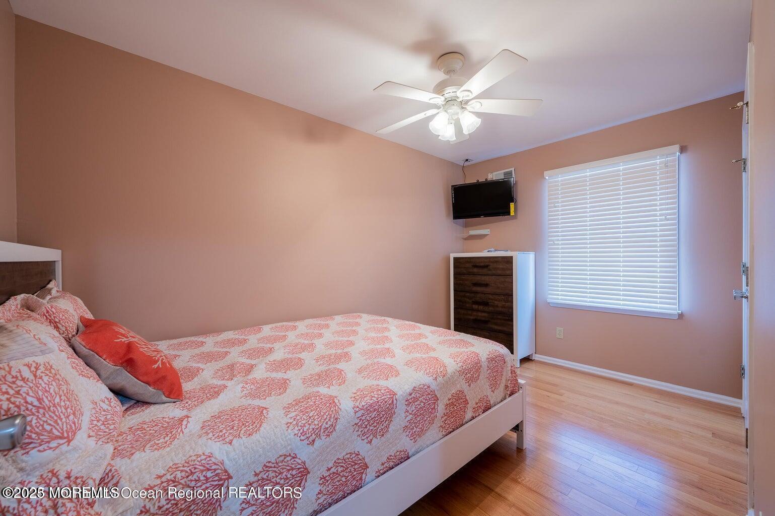 204 Coolidge Avenue Seaside Heights, NJ 08751 - Photo 9 of 22 a bedroom with a large bed and a tv