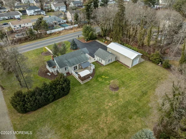 an aerial view of a house with garden space and street view