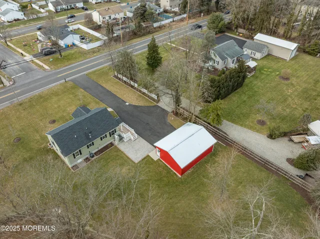 an aerial view of residential house with pool
