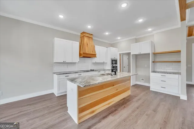 a kitchen with stainless steel appliances granite countertop a stove and a sink