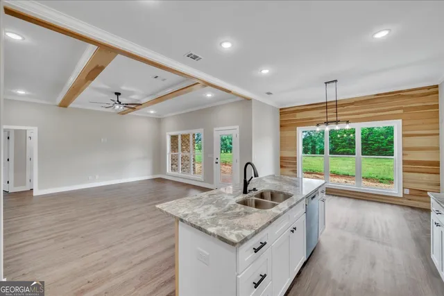 a kitchen with a sink and large window