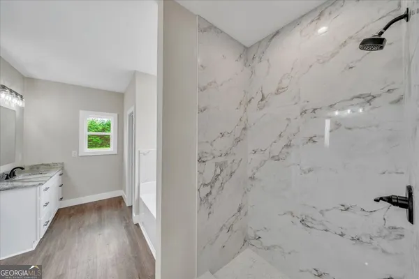 a bathroom with a bathtub and shower