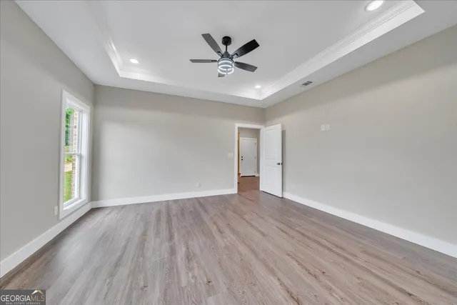 wooden floor in an empty room with a window