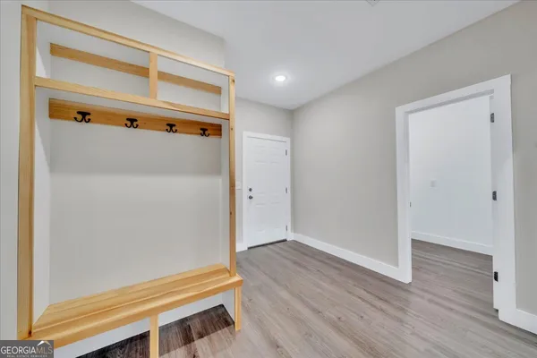 a view of room with wooden floor