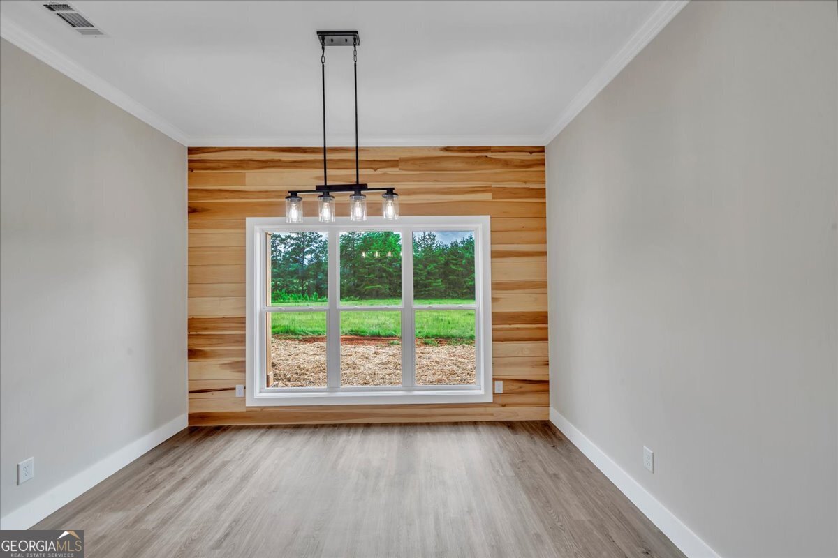 87 River Ridge Drive Hawkinsville, GA 31036 - Photo 28 of 65 a view of an empty room with a window and wooden floor