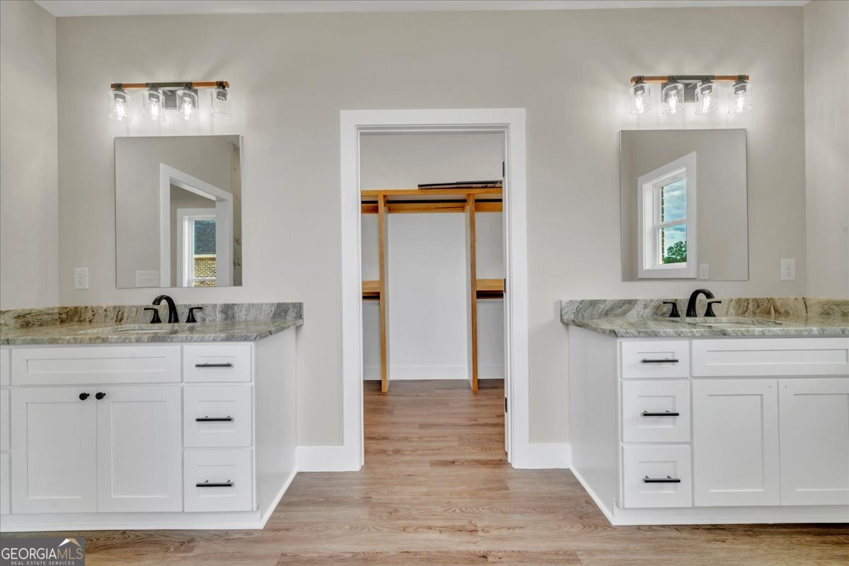 87 River Ridge Drive Hawkinsville, GA 31036 - Photo 40 of 65 a bathroom with a granite countertop sink mirror and a