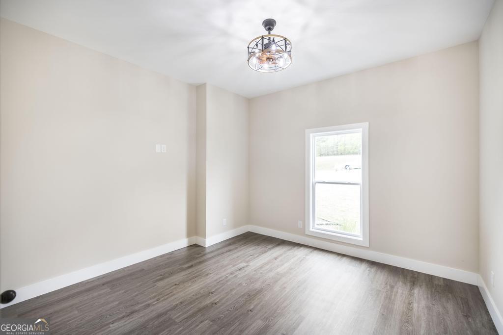 87 River Ridge Drive Hawkinsville, GA 31036 - Photo 41 of 65 an empty room with wooden floor and window