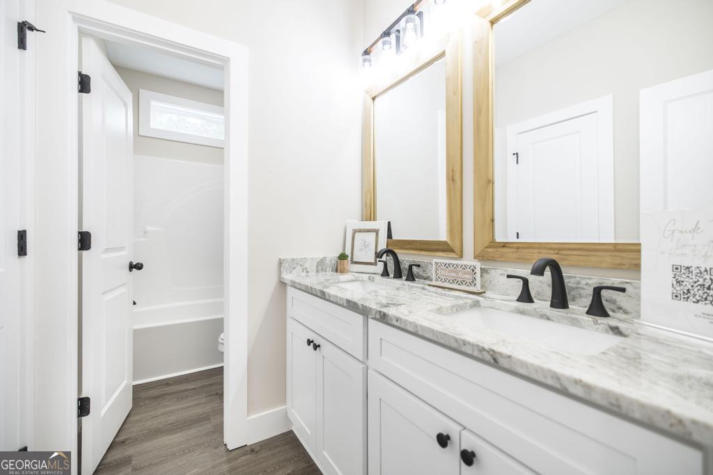 87 River Ridge Drive Hawkinsville, GA 31036 - Photo 49 of 65 a bathroom with a granite countertop sink and a mirror