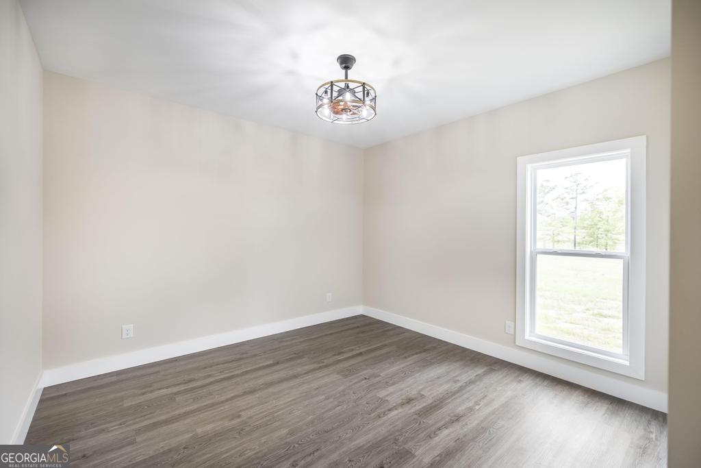 87 River Ridge Drive Hawkinsville, GA 31036 - Photo 51 of 65 an empty room with wooden floor and window