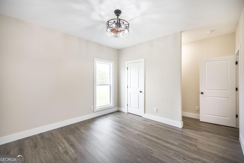 87 River Ridge Drive Hawkinsville, GA 31036 - Photo 53 of 65 a view of a room with wooden floor and a ceiling fan