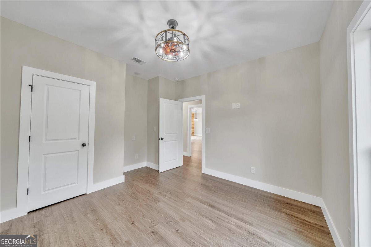 87 River Ridge Drive Hawkinsville, GA 31036 - Photo 60 of 65 a view of an empty room with wooden floor