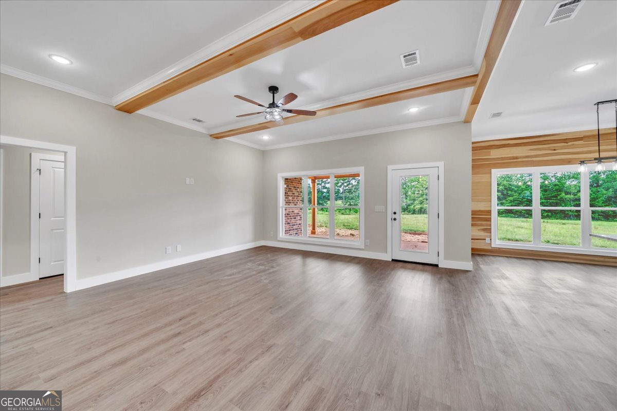 87 River Ridge Drive Hawkinsville, GA 31036 - Photo 6 of 65 a view of an empty room with wooden floor and a window