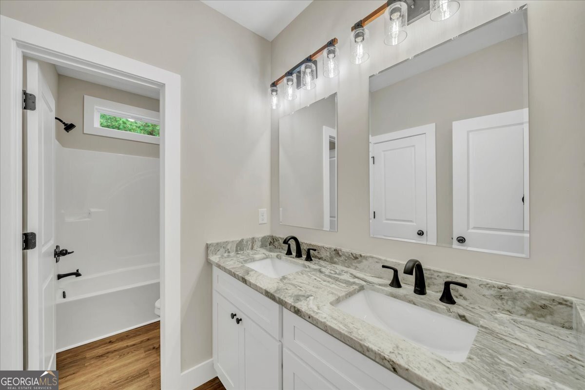 87 River Ridge Drive Hawkinsville, GA 31036 - Photo 63 of 65 a bathroom with a granite countertop sink and a mirror
