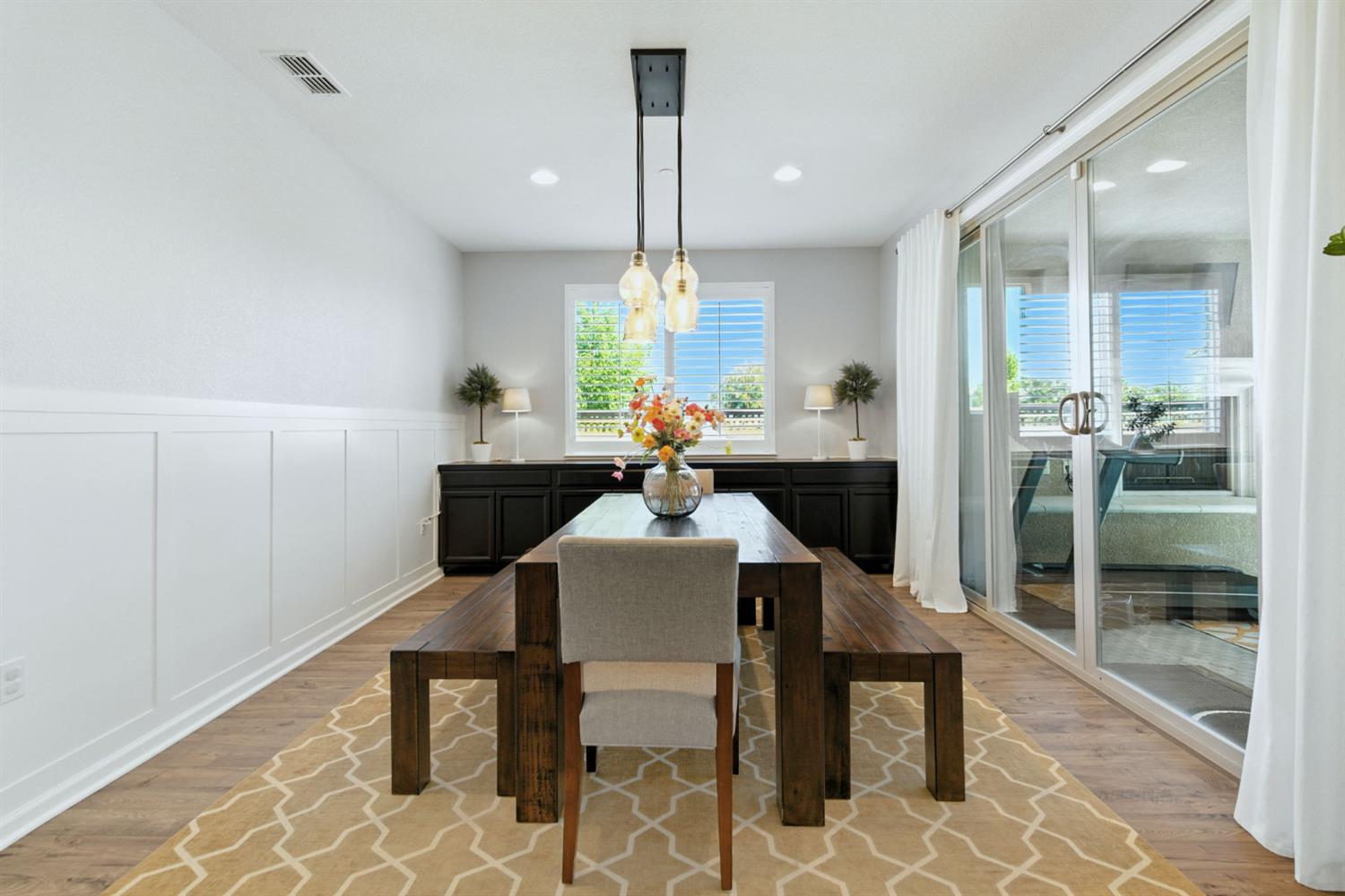 18200 Broadmoor Way Lathrop, CA 95330 - Photo 22 of 48 dining room featuring wainscoting, wood finished floors, a decorative wall, and recessed lighting