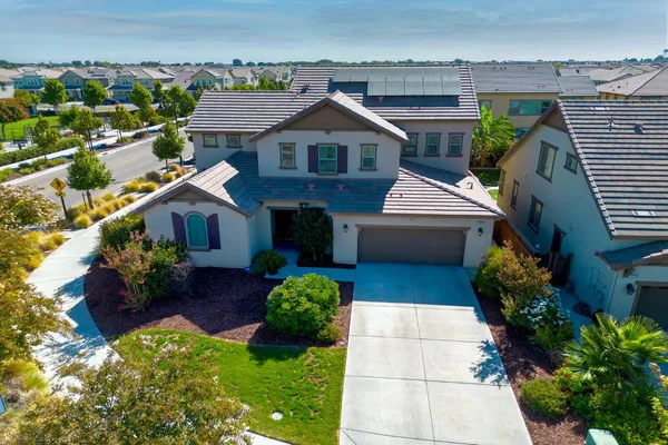 a front view of house with yard and green space
