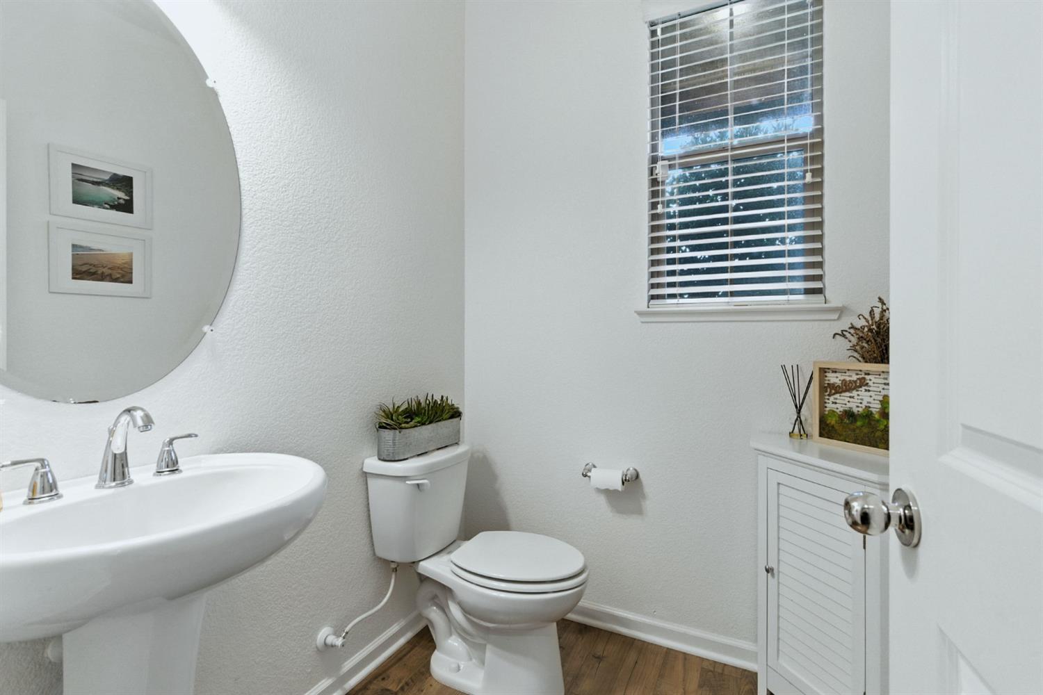 18200 Broadmoor Way Lathrop, CA 95330 - Photo 38 of 48 half bath with dark wood finished floors and a textured wall