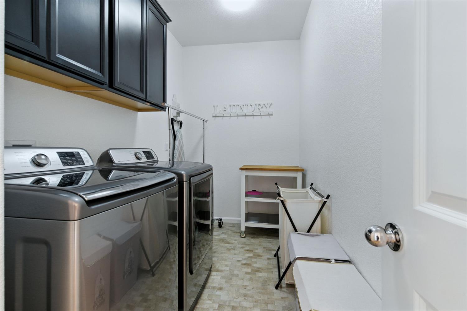 18200 Broadmoor Way Lathrop, CA 95330 - Photo 39 of 48 laundry area featuring cabinet space and washing machine and clothes dryer