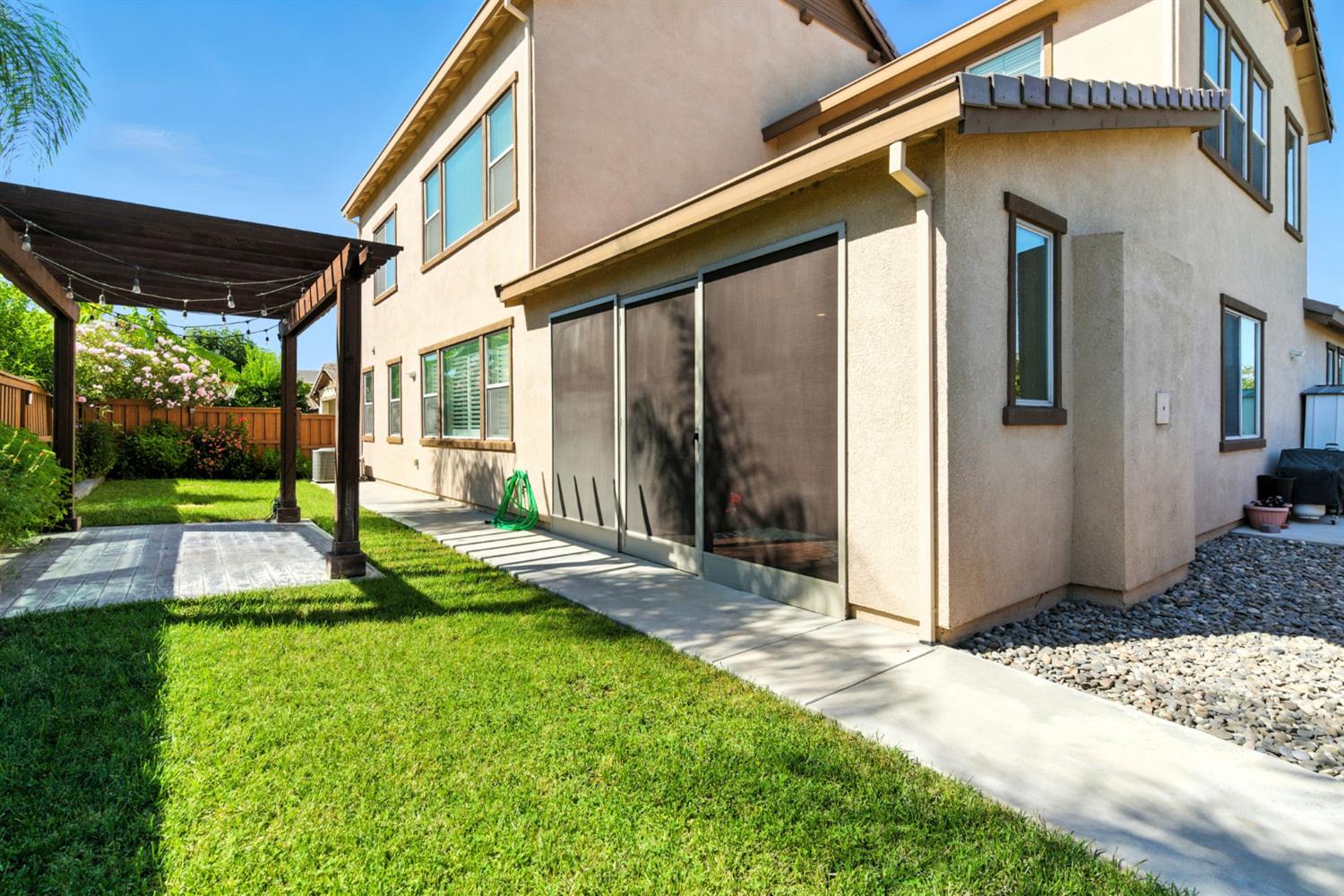 18200 Broadmoor Way Lathrop, CA 95330 - Photo 42 of 48 back of property with stucco siding and a patio