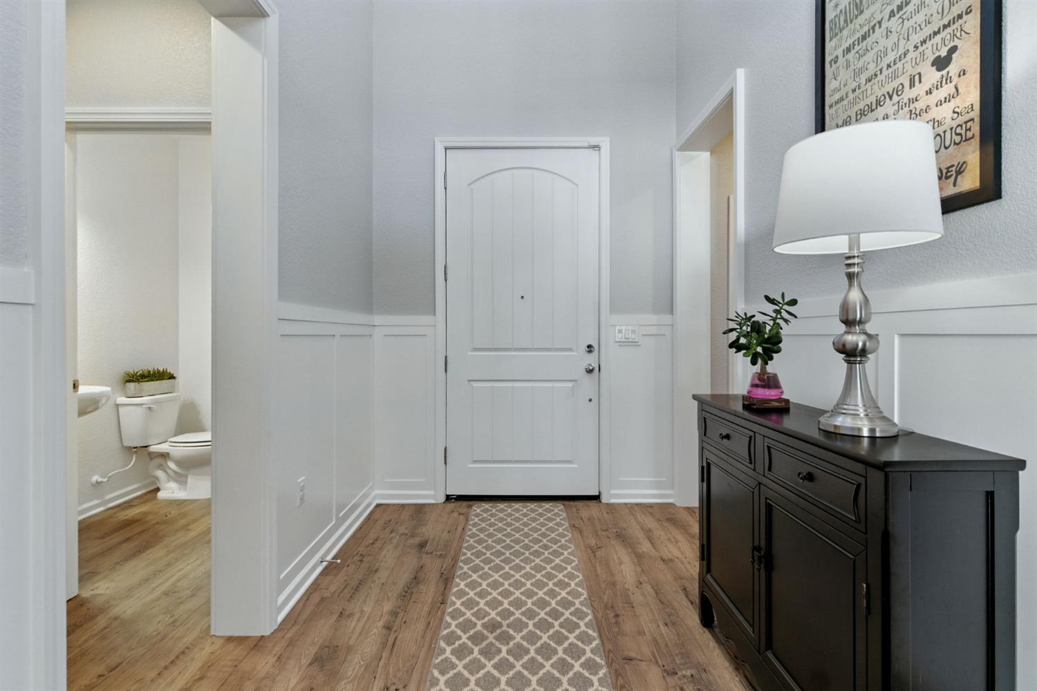 18200 Broadmoor Way Lathrop, CA 95330 - Photo 7 of 48 entrance foyer with light wood-style flooring, a decorative wall, and wainscoting