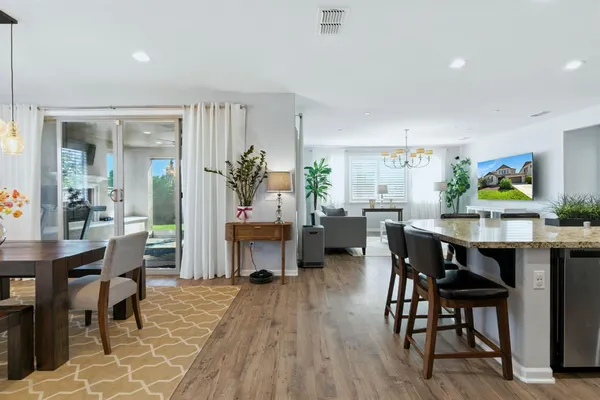 a kitchen with counter space dining table and chairs