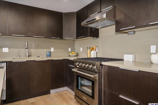 a living room with kitchen island granite countertop furniture and a wooden floor